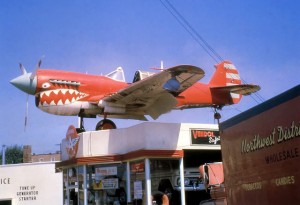 Airplane atop gas station.